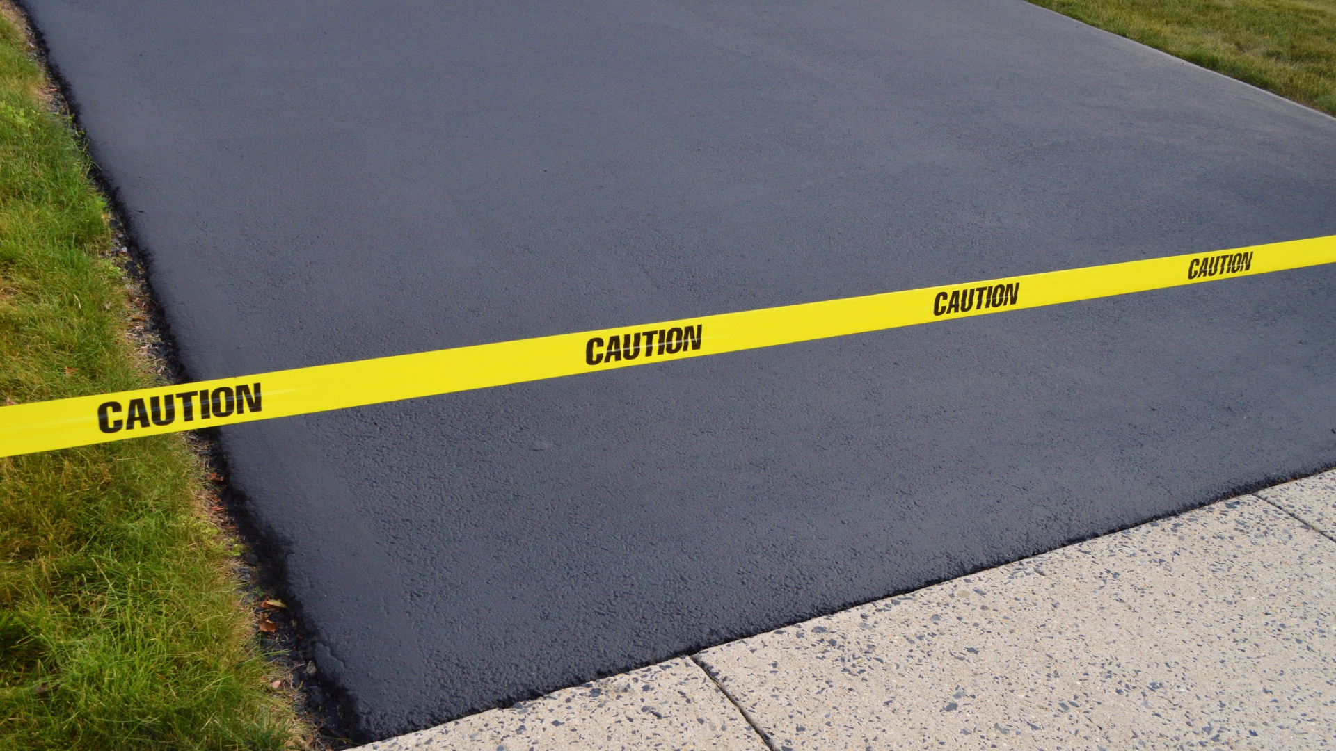 A yellow caution tape on the side of a road