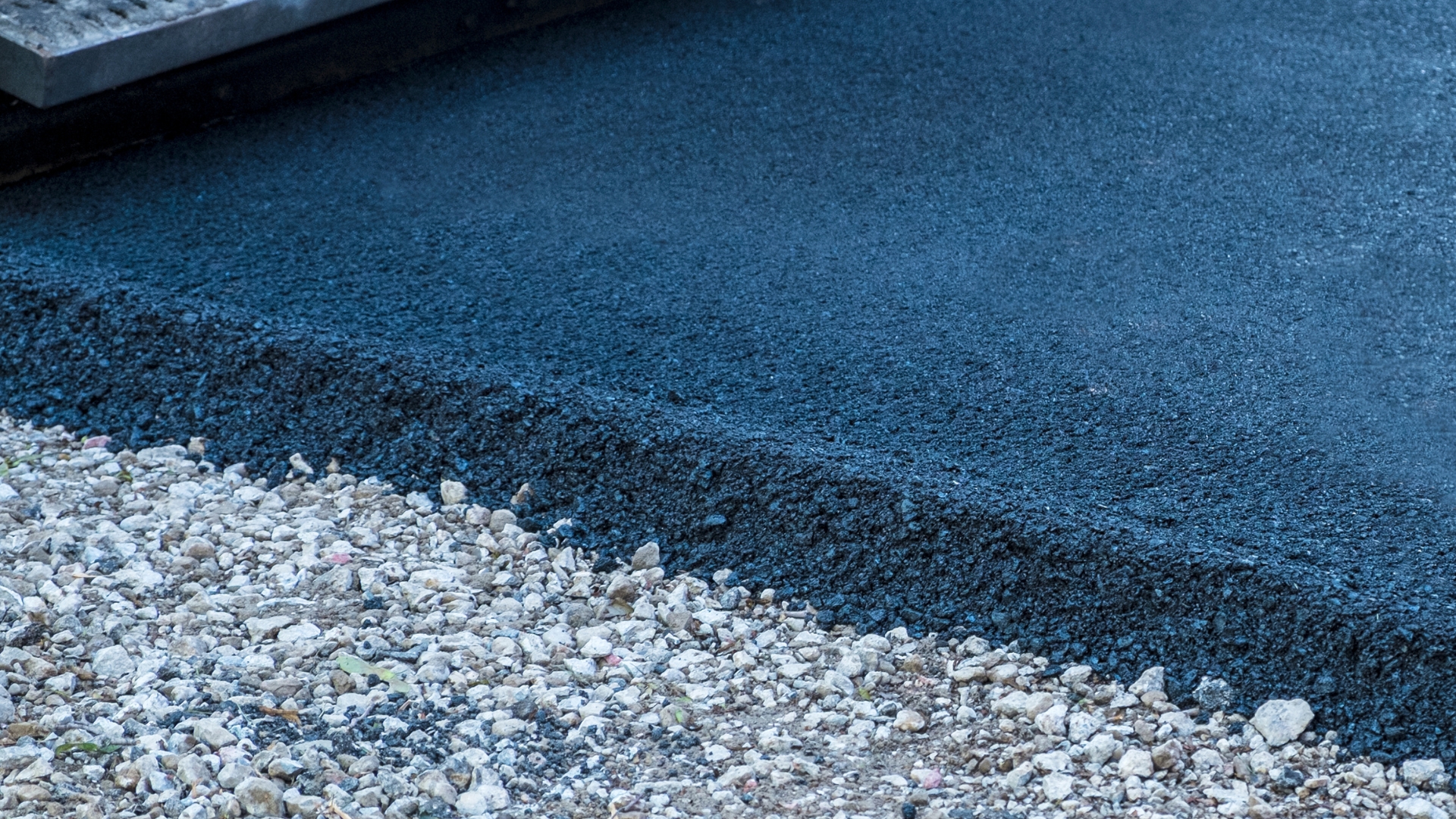 A close up of a road with gravel and rocks